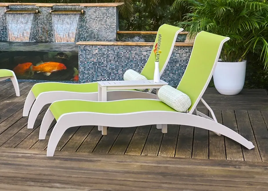 Contemporary poolside chaise lounges with lime green sling fabric and white frames creating a vibrant tropical resort atmosphere.